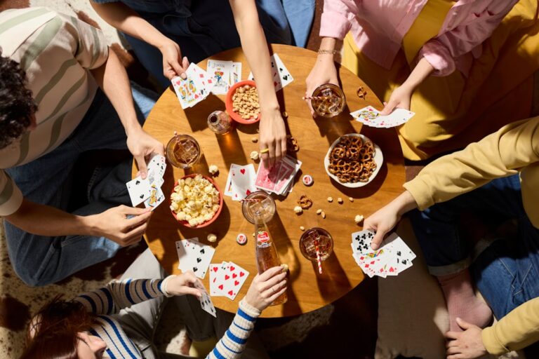 friends seated around game table — photo by Sidral Mundet on Unsplash