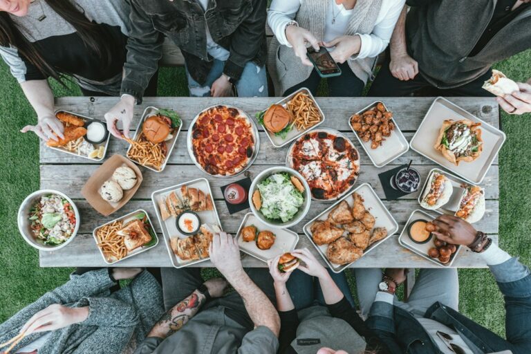 friends sharing snacks at table — photo by Spencer Davis on Unsplash