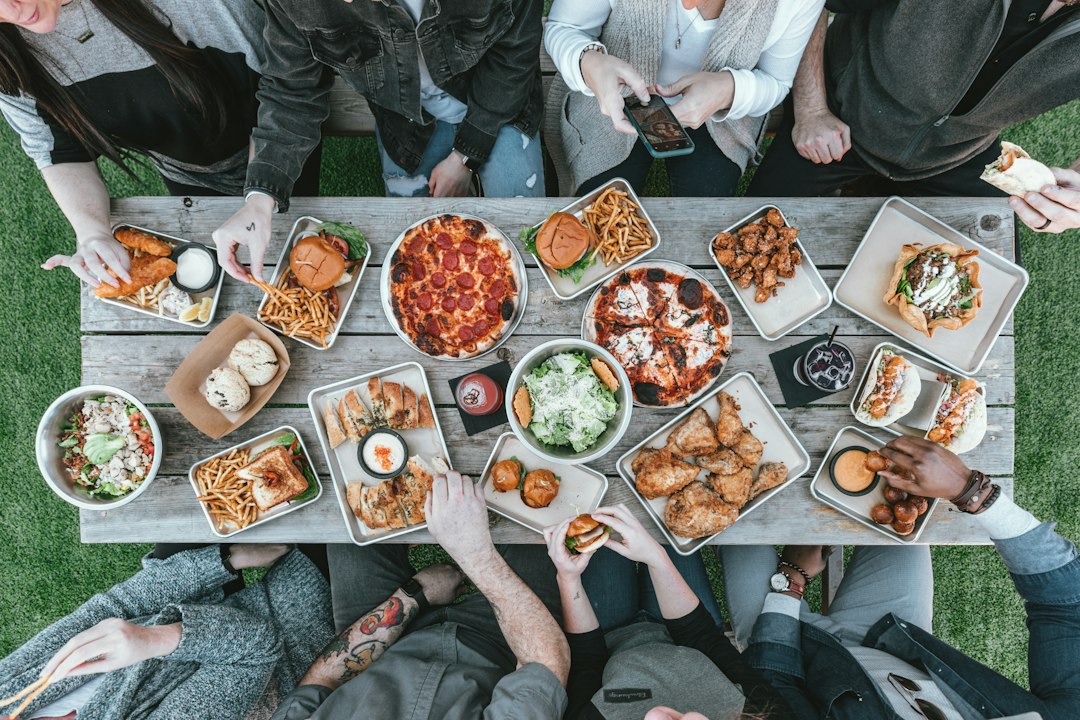 friends sharing snacks at table — photo by Spencer Davis on Unsplash