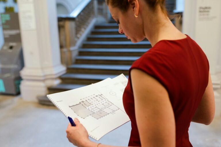 woman studying paper chart closely — photo by ThisisEngineering on Unsplash