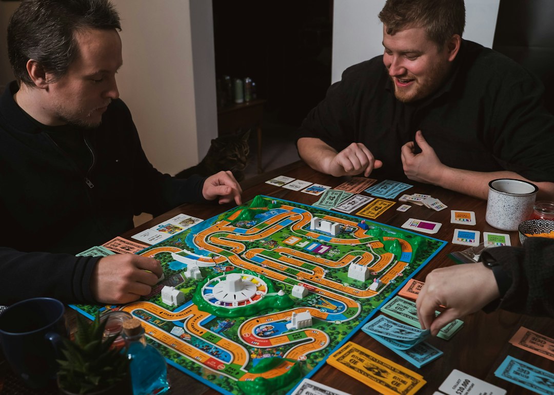 friends laughing during board game — photo by 2H Media on Unsplash