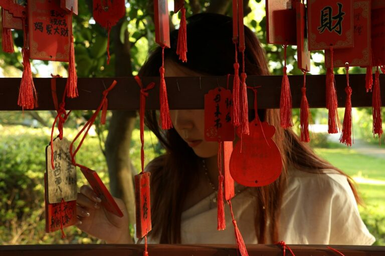 woman touching lucky charm bracelet — photo by Yanhao Fang on Unsplash